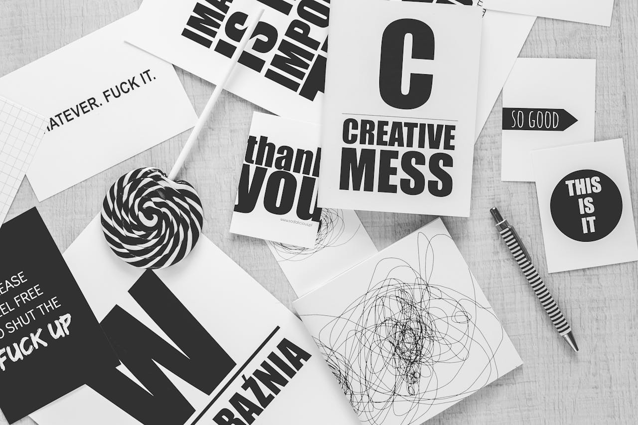 Crafting Captivating Headlines: Your awesome post title goes here Monochrome desk scene with creative typography, candies, and a striped pen.